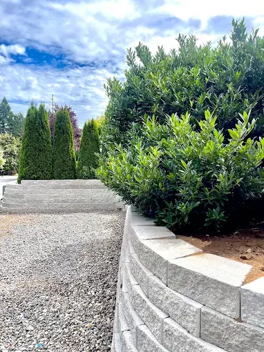 Block retaining wall enclosing a graded gravel yard