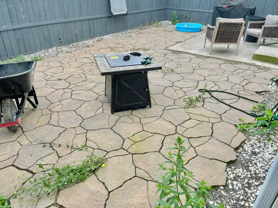 Flagstone patio with a fire table and patio furniture